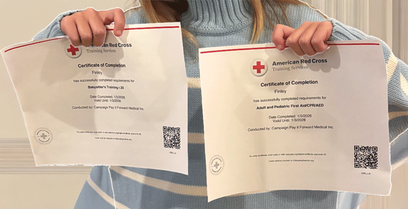 A babysitter holding her First Aid certifications